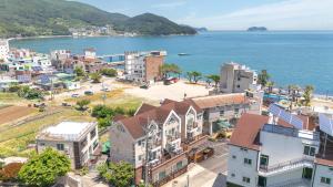 an aerial view of a town next to the ocean at Geoje Blueberry Pet Pension in Geoje