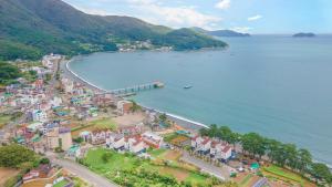an aerial view of a town next to the water at Geoje Blueberry Pet Pension in Geoje