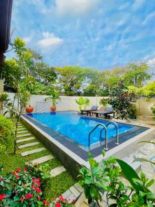 a swimming pool in the middle of a garden at Mount Top in Dickwella