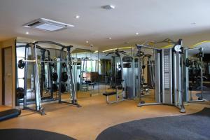 a gym with a bunch of equipment in a room at Pamookkoo in Kata Beach