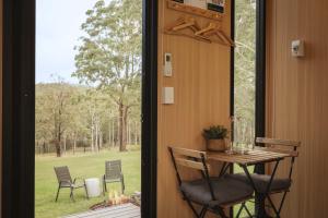 a room with a table and chairs and a window at Two-Ki by Tiny Away in Rainbow Flat