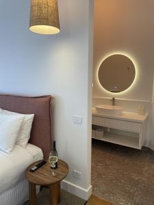 a bedroom with a bed and a table with a mirror at The Porcupine Place in Sale