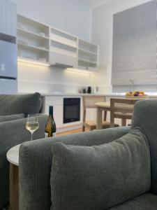 a living room with two couches and a wine glass at The Porcupine Place in Sale +12 photos