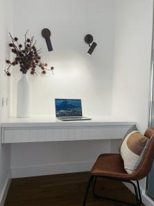 a desk with a laptop and a chair in a room at The Porcupine Place in Sale