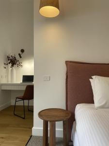 a bedroom with a bed and a table and a desk at The Porcupine Place in Sale