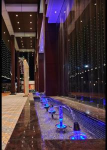 a row of blue wine glasses in a building at Hotel SS Palace in Gaya