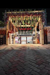 a large building with a flag and flowers on it at Hotel SS Palace in Gaya