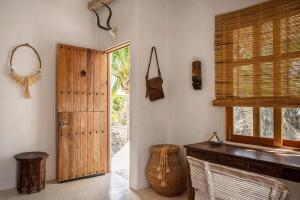 a room with a wooden door and a window at Holbox island Casa Impala in Holbox Island