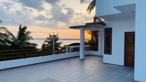 a view of the ocean from the balcony of a house at Harbour Front Villa in Trincomalee