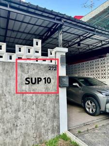 a car parked in a parking lot with a super sign at 9 mins to BTS Queen Bed Private Room - Share Bath in Amphoe Phra Khanong