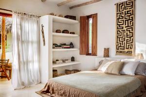a bedroom with a large bed and a window at Holbox island Casa Impala in Holbox Island +31 photos