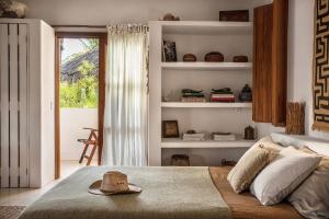 a bedroom with a bed with a hat on it at Holbox island Casa Impala in Holbox Island