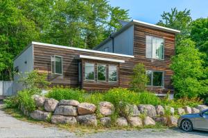 a log home with a car parked in front of it at The Crag On the Acadia National Park Border - Deck, Fire Pit, Steps to Trails in Otter Creek