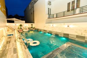 a pool in a building with a swimming pool at Sunny - Việt House in Kỳ Vĩ
