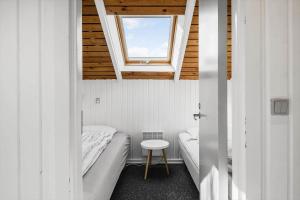 a small room with two beds and a window at 0658-Toftlund-Ostmarken-56 in Toftlund +26 photos