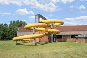 a set of yellow inflatable slides in front of a building at 0658-Toftlund-Ostmarken-56 in Toftlund