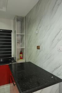 a kitchen with a black counter top in a room at Maison Madame - Female only Shared Apartment Lekki in Lekki