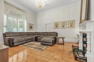 a living room with a couch and a fireplace at Central Charm in Echuca +16 photos
