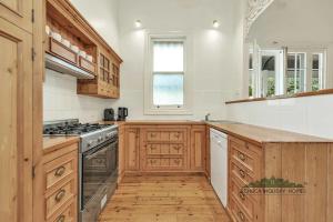a kitchen with wooden cabinets and a stove top oven at Central Charm in Echuca