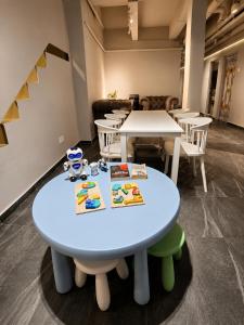 a table with books on it in a room with tables and chairs at Space Hotel KL Sentral in Kuala Lumpur