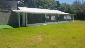 a screened in porch of a house with a yard at El Campito in Abasto
