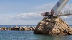 a bridge on top of a rock in the water at Samcheok Sea Road Pension in Samcheok +3 photos