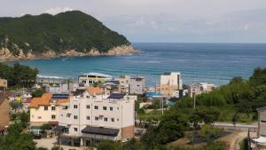 a view of a city and the ocean at Samcheok Sea Road Pension in Samcheok