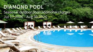 a sign for a pool with lounge chairs and a swimming pool at The Prince Sakura Tower Tokyo, Autograph Collection in Tokyo