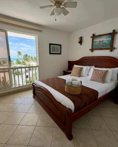 a bedroom with a bed with a view of the ocean at Exclusivo Departamento playa in Same +10 photos