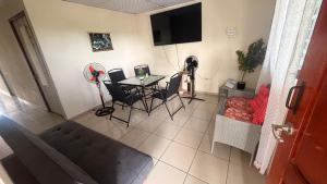a living room with a table and chairs and a television at Hostal Flores in David
