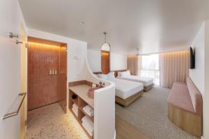 a hotel room with a bed and a bathroom at Bounce Surfers in Gold Coast +25 photos