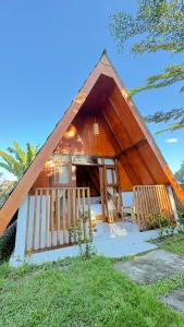 a small house with a thatched roof at D' Rinjani View Bungalow in Masbagik