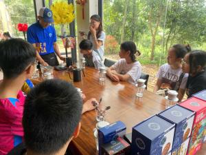 a group of people sitting around a table at Mountain Hill in Mai Sơn