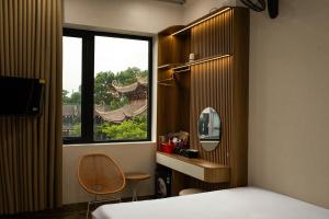 a bedroom with a bed and a window with a mirror at Trang An Harmony Hotel in Ninh Binh
