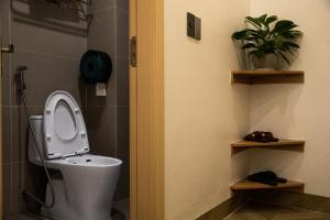 a bathroom with a toilet with the seat up at Trang An Harmony Hotel in Ninh Binh