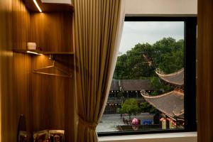a window with a curtain in a room at Trang An Harmony Hotel in Ninh Binh +27 photos