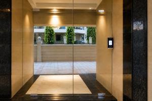 a lobby with a glass door in a building at ASPA Apartments in Navi Mumbai