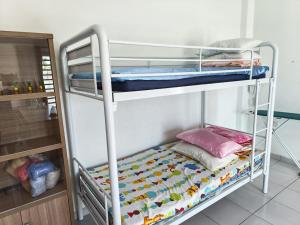 a bunk bed room with two bunk beds at Sun Flower Guest House 17mins to Ipoh Town in Ipoh +65 photos
