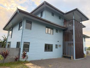 a white house with a black roof at Fare Manihinihi 2BR APPARTMENT TARAVAO CENTER in Mitirapa