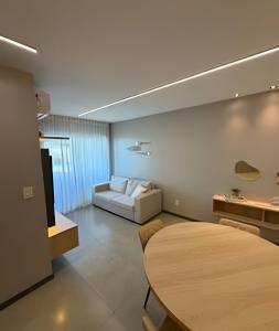 a living room with a white couch and a table at Flat 2/4 - Prestige 204 - Praia do Francês in Marechal Deodoro +29 photos