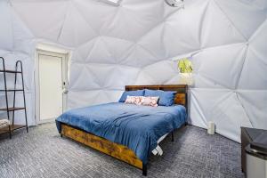 a bedroom with a bed in a tent at Pleasant River Glamping Dome 3 King bed in Bethel