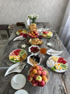 a table with many plates of food on it at Rest House in Bokonbayevo +15 photos