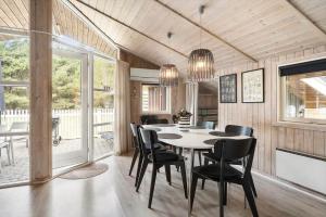 a dining room with a table and chairs at 0011-Romo-Trinnesvej-9 in Høm