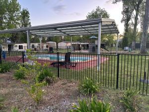 a pavilion over a playground with a pool at Corryong Caravan Park in Corryong
