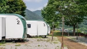 two trailers parked next to each other in a field at Gapyeong 516geullaemlaban in Gapyeong