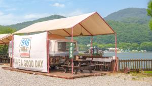 a food truck tent with a table and chairs at Gapyeong 516geullaemlaban in Gapyeong