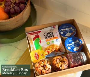 a box of breakfast box monkeyberry friday and a bowl of fruit at Alpine Hotel, Eat Drink Sleep in Warburton