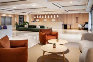 a lobby with couches and chairs and tables at Meliá Lloret de Mar in Lloret de Mar