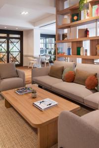 a living room with two couches and a coffee table at Meliá Lloret de Mar in Lloret de Mar +96 photos