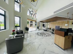 an office lobby with a reception desk and chairs at Sala Lan Anh hotel in Phước Long